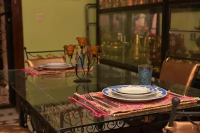 a glass table with plates on top of it at DarSaouiri55 in Marrakech