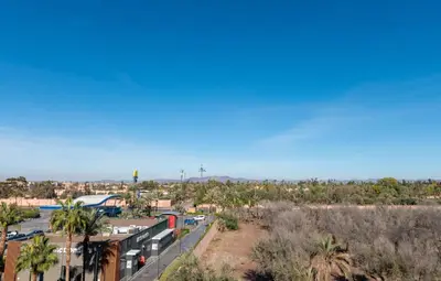 a view of a town with palm trees and a train at DarSaouiri55 in Marrakech