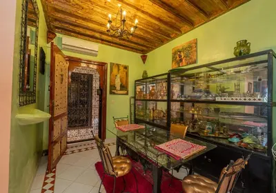 a dining room with a table and chairs in a room at DarSaouiri55 in Marrakech
