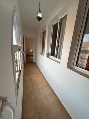 a hallway with two windows and a tiled floor at Appartement 3 Chambres 140 m Najd, Calme & Confort in Marrakech