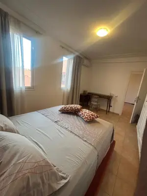 a bedroom with a bed with two pillows on it at Appartement 3 Chambres 140 m Najd, Calme & Confort in Marrakech