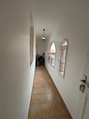 a hallway with two windows and a tile floor at Appartement 3 Chambres 140 m Najd, Calme & Confort in Marrakech