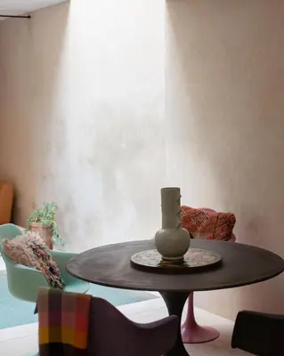 a table with a vase on it in a room at Dar Alma Modernist Designer Riad with Pool in Marrakech