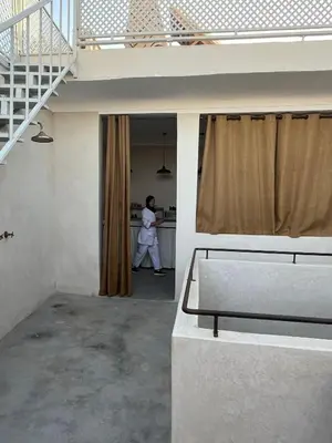 a man in a white robe in a room at Dar Alma Modernist Designer Riad with Pool in Marrakech