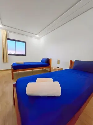 a room with two beds and a blue blanket at Burj Malak Duplex Villa Serenitas in Marrakech