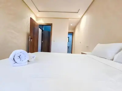 a bedroom with a bed with a clock on it at Burj Malak Duplex Villa Serenitas in Marrakech
