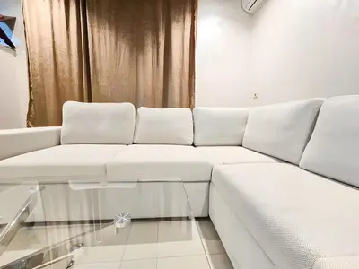 a white couch in a room with a window at Burj Malak Duplex Villa Serenitas in Marrakech