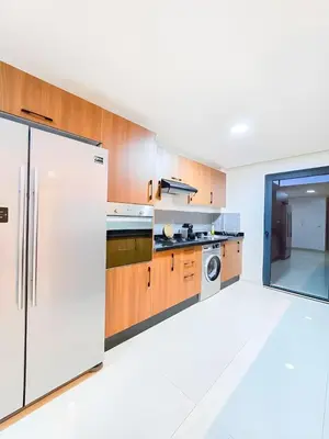 a kitchen with a refrigerator and a washer and dryer at Burj Malak Duplex Villa Serenitas in Marrakech