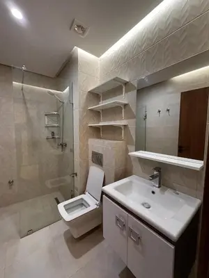 a bathroom with a toilet and a sink and a shower at Appartement luxueux au centre in Marrakech