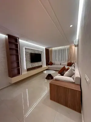 a living room with a couch and a tv at Appartement luxueux au centre in Marrakech