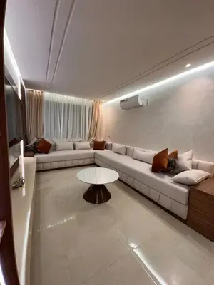 a living room with a couch and a table at Appartement luxueux au centre in Marrakech