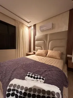 a bedroom with a large bed in a room at Appartement luxueux au centre in Marrakech