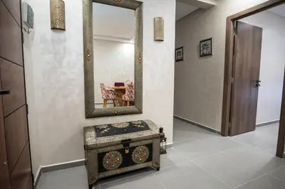 a dressing room with a mirror and a table at Oasis Urban avec Balcon - 5min de l'aéroport in Marrakech