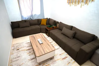 a living room with a couch and a coffee table at Haven Cosy avec Piscine in Marrakech