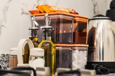 a kitchen counter with bottles of olive oil and a toaster at Haven Cosy avec Piscine in Marrakech