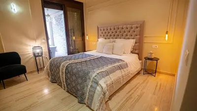 a bedroom with a large bed in a room at Appartement moderne terrasse avec baignoire privée in Marrakech