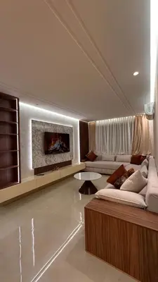 a living room with a couch and a fireplace at Appartement luxueux avec piscine in Marrakech