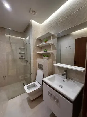 a bathroom with a toilet and a sink and a shower at Appartement luxueux avec piscine in Marrakech