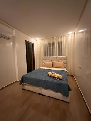 a bedroom with a bed with a blue comforter at Appartement luxueux avec piscine in Marrakech