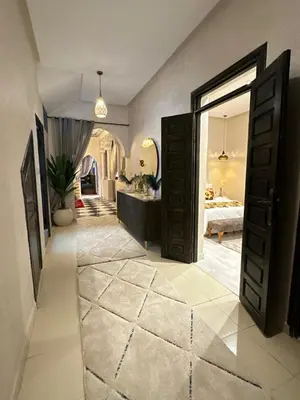 a hallway with two open doors and a bathroom at appartement pour famille in Marrakech