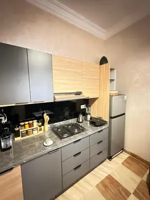 a kitchen with a stove and a refrigerator at appartement pour famille in Marrakech