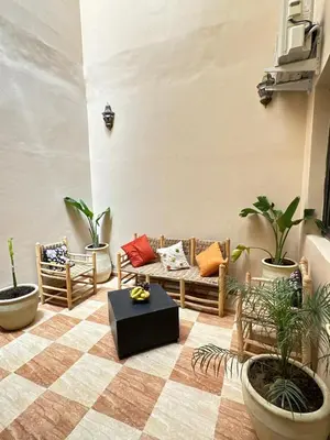 a living room with couches and potted plants at appartement pour famille in Marrakech