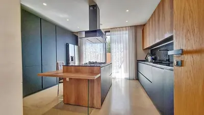 a kitchen with blue cabinets and a wooden counter top at Ville d'Exception Marrakech in Marrakech