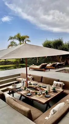 a table with an umbrella on a patio at Ville d'Exception Marrakech in Marrakech