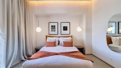 a bedroom with a large bed and a mirror at Ville d'Exception Marrakech in Marrakech