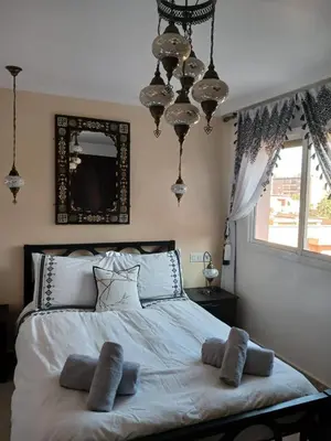 a bedroom with a large bed with pillows on it at Kasbah Bastoff in Marrakech