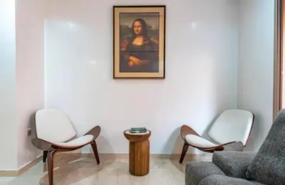 a living room with two chairs and a couch at Appartement Luxe Gueliz Piscine & Spa in Marrakech