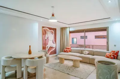 a living room with a couch and a table at Appartement Luxe Gueliz Piscine & Spa in Marrakech