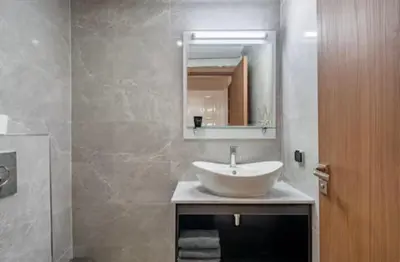 a bathroom with a white sink and a mirror at Appartement Luxe Gueliz Piscine & Spa in Marrakech