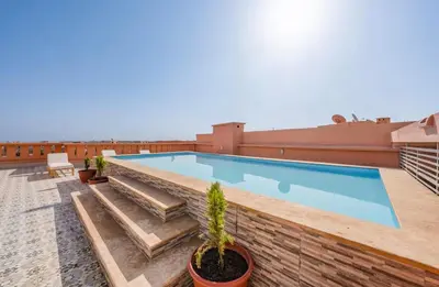 a swimming pool on the roof of a building at Appartement Luxe Gueliz Piscine & Spa in Marrakech
