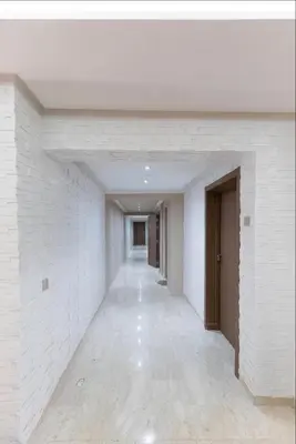 an empty hallway with white walls and white floors at Appartement Luxe Gueliz Piscine & Spa in Marrakech