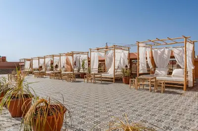 a row of tents with chairs and potted plants at Appartement Luxe Gueliz Piscine & Spa in Marrakech