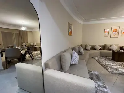 a living room with a couch and a mirror at appartement de luxe dans le centre de marrakech in Marrakech
