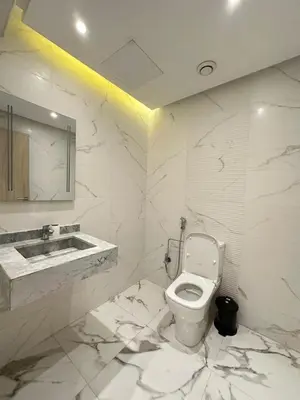 a white bathroom with a toilet and a sink at Elegant 2 bedroom apartment in Palmeraie Gates in Marrakech