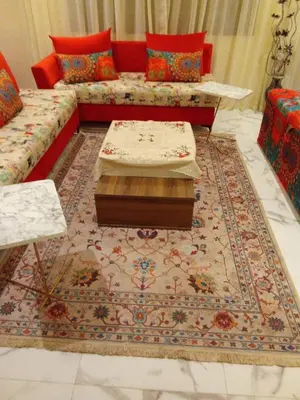 a living room with a couch and a rug at Elegant 2 bedroom apartment in Palmeraie Gates in Marrakech