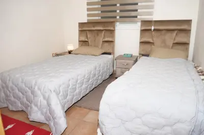 a bedroom with two white beds in a room at Calm Spacious Family Apartment Close To Coty in Marrakech