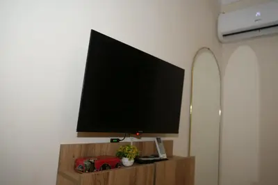 a flat screen tv sitting on top of a tv stand at Calm Spacious Family Apartment Close To Coty in Marrakech