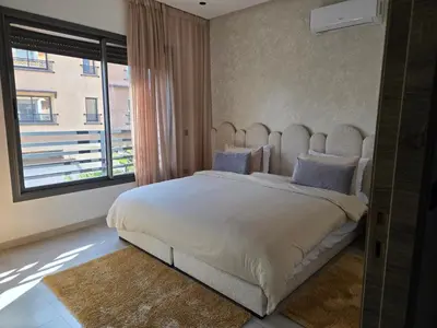 a bedroom with a large bed with a large window at luxury apartment in Marrakech center in Marrakech