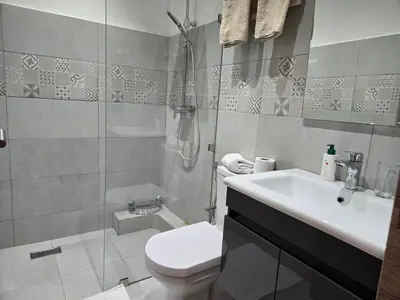 a bathroom with a toilet and a sink and a shower at luxury apartment in Marrakech center in Marrakech