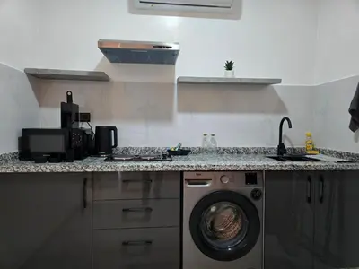 a kitchen with a washing machine and a sink at luxury apartment in Marrakech center in Marrakech