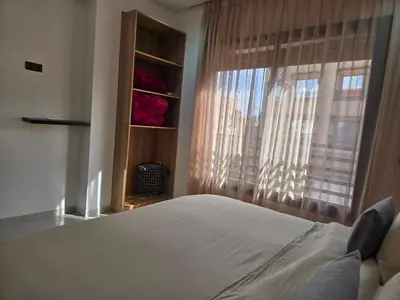 a bedroom with a white bed and a window at luxury apartment in Marrakech center in Marrakech