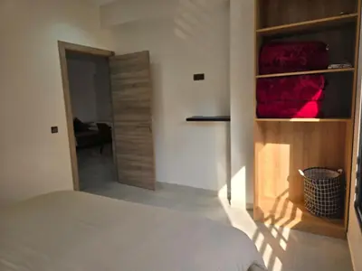 a bedroom with a bed and a closet with red blankets at luxury apartment in Marrakech center in Marrakech