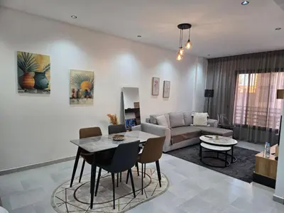 a living room with a table and a couch at luxury apartment in Marrakech center in Marrakech