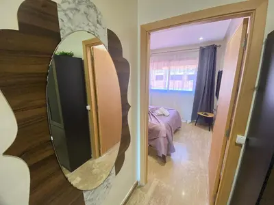a mirror in a room with a bedroom and a bed at Small Cosy & Balcon & Vue Palmier et Montagne in Marrakech