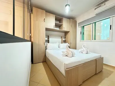 a bedroom with a bed with two swans on it at Marrakech-Central studio in Guéliz - WiFi, Netflix in Marrakech