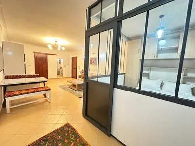 a room with a large window and a room with a bed at Marrakech-Central studio in Guéliz - WiFi, Netflix in Marrakech